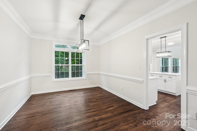 5745 Snapdragon Ln, Huntersville, NC 28078 - unfurnished dining area with dark wood-type flooring, ornamental molding, baseboards, and a chandelier