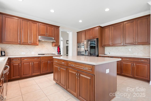 7525 Blackgum Falls Ct, Huntersville, NC 28078 - kitchen featuring appliances with stainless steel finishes, light tile patterned floors, tasteful backsplash, under cabinet range hood, and a kitchen island