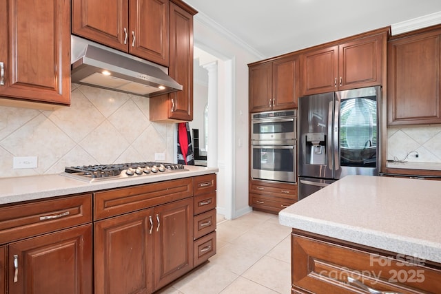 7525 Blackgum Falls Ct, Huntersville, NC 28078 - kitchen featuring light tile patterned flooring, stainless steel appliances, backsplash, under cabinet range hood, and ornamental molding