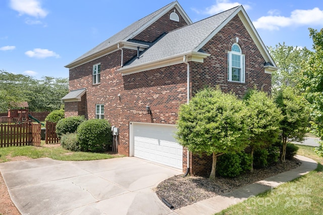 7525 Blackgum Falls Ct, Huntersville, NC 28078 - view of side of property featuring fence, a shingled roof, brick siding, a garage, and concrete driveway
