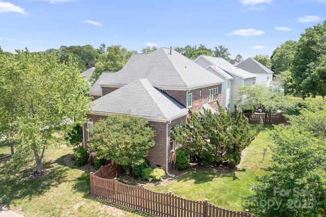 7525 Blackgum Falls Ct, Huntersville, NC 28078 - view of side of property with brick siding, a fenced backyard, roof with shingles, and a yard