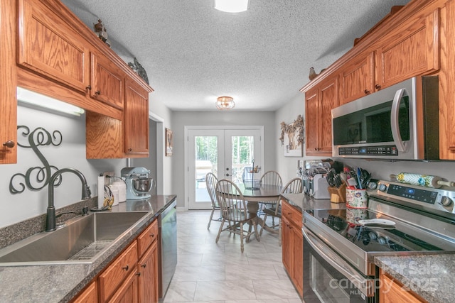 1800 Oriole Ct, Monroe, NC 28112 - kitchen with french doors, a sink, brown cabinetry, and appliances with stainless steel finishes