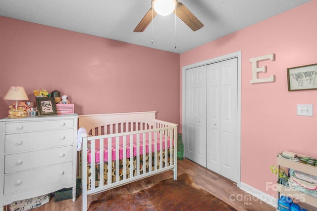 1800 Oriole Ct, Monroe, NC 28112 - bedroom featuring a nursery area, baseboards, wood finished floors, and a closet