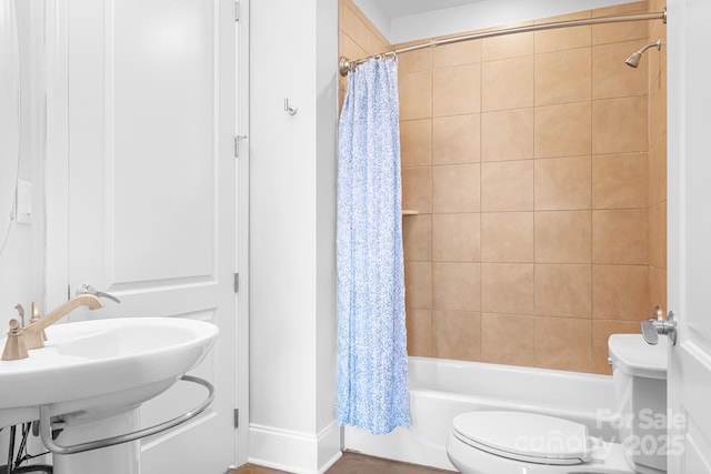 bathroom featuring toilet and shower / bath combo with shower curtain