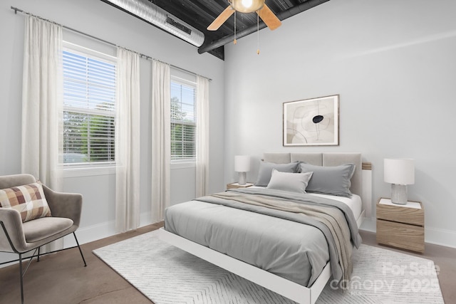 bedroom featuring baseboards, multiple windows, and a ceiling fan