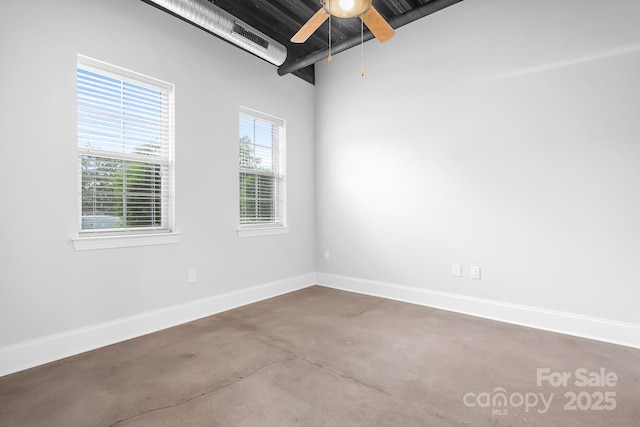 spare room with concrete flooring, baseboards, and ceiling fan