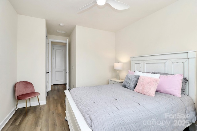 bedroom with baseboards, a ceiling fan, and wood finished floors