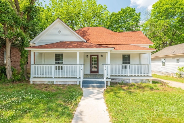 bungalow-style home featuring a porch, a shingled roof, and a front yard