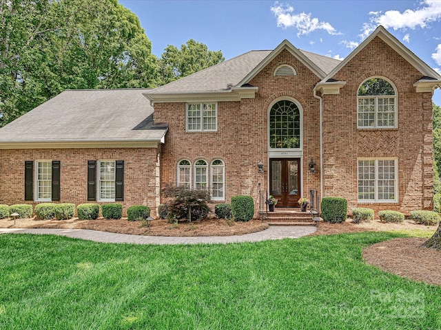 4701 Pineland Pl, Charlotte, NC 28277 - view of front facade featuring a front lawn, brick siding, and french doors