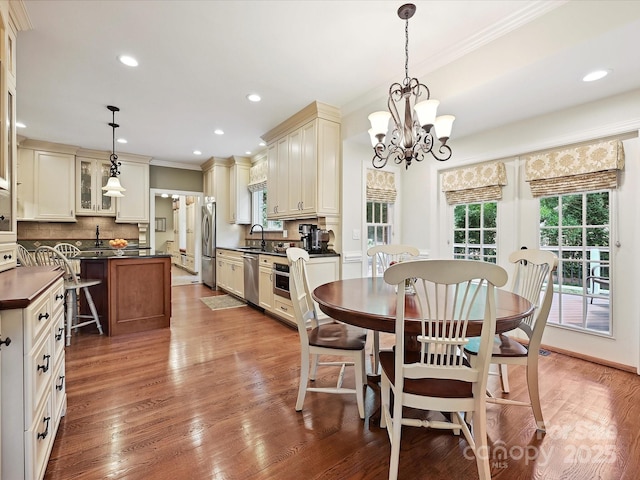 4701 Pineland Pl, Charlotte, NC 28277 - dining room featuring crown molding, recessed lighting, a notable chandelier, and wood finished floors
