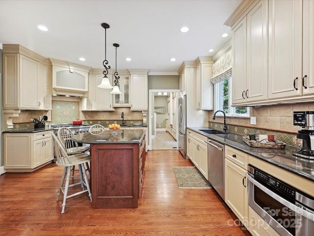 4701 Pineland Pl, Charlotte, NC 28277 - kitchen with a sink, stainless steel appliances, decorative backsplash, and a breakfast bar