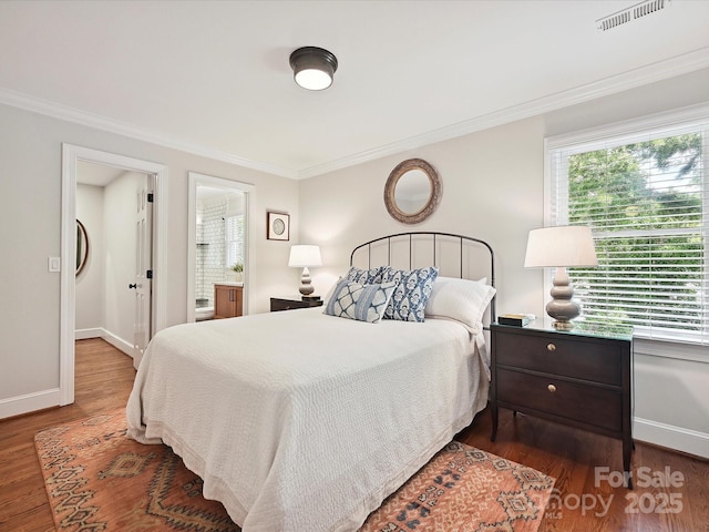 4701 Pineland Pl, Charlotte, NC 28277 - bedroom featuring baseboards, ensuite bath, visible vents, crown molding, and wood finished floors