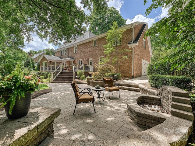 4701 Pineland Pl, Charlotte, NC 28277 - view of patio featuring stairway, a deck, and a fire pit