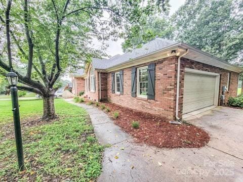6231 Kentwood Dr, Kannapolis, NC 28081 - view of property exterior featuring driveway, a garage, and brick siding
