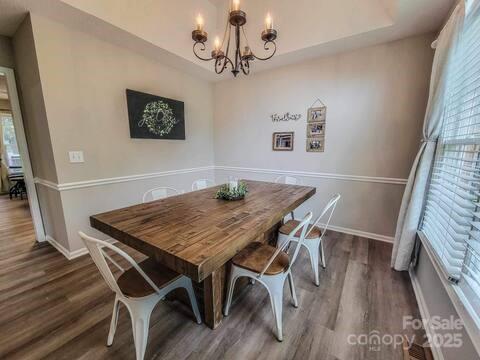 6231 Kentwood Dr, Kannapolis, NC 28081 - dining space with a chandelier and dark wood-style flooring