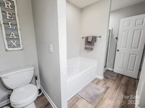6231 Kentwood Dr, Kannapolis, NC 28081 - bathroom with wood finished floors, a shower with door, and a garden tub
