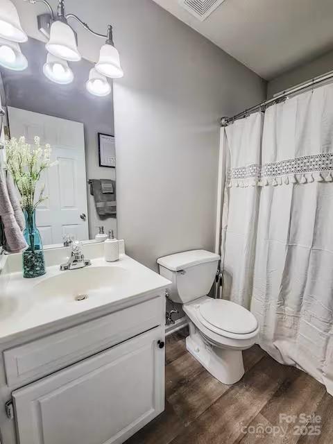 6231 Kentwood Dr, Kannapolis, NC 28081 - full bathroom with vanity, wood finished floors, and curtained shower