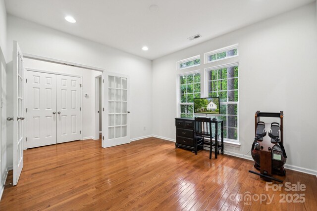 office featuring visible vents, recessed lighting, baseboards, and wood finished floors