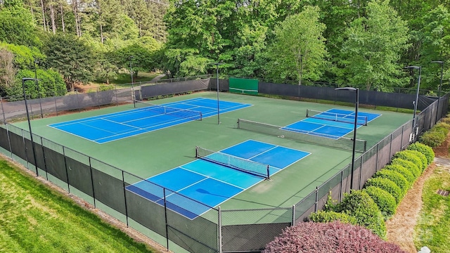 109 Braxton Gate Ct, Mount Holly, NC 28120 - view of tennis court featuring fence and a wooded view