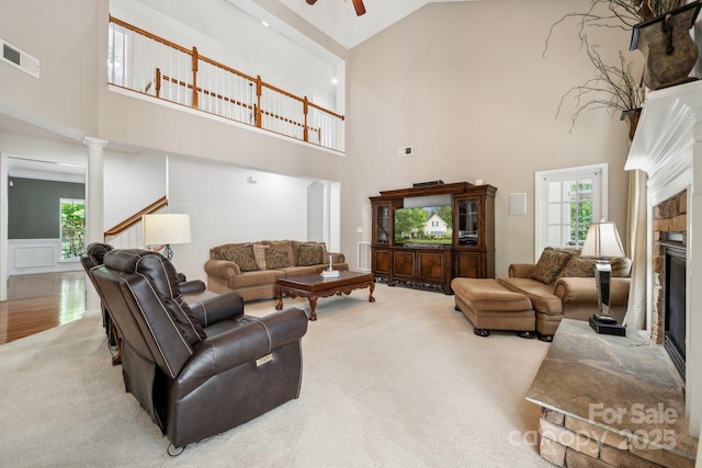 109 Braxton Gate Ct, Mount Holly, NC 28120 - living area featuring high vaulted ceiling, carpet, a stone fireplace, ceiling fan, and stairs