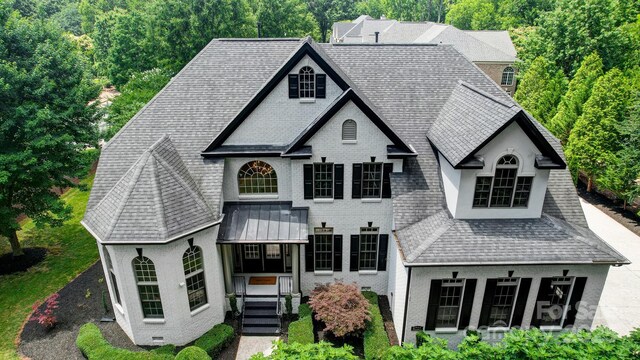 8707 Fairview Rd, Charlotte, NC 28226 - french country home with a shingled roof, brick siding, and stucco siding