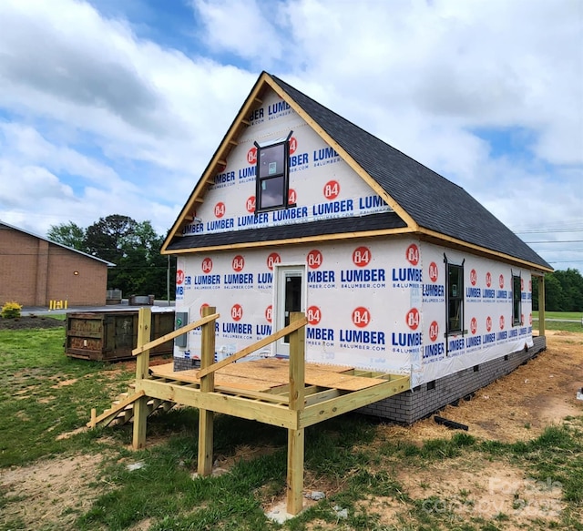 exterior space featuring roof with shingles and crawl space