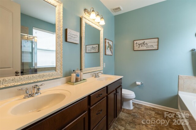 3186 Helmsley Ct, Concord, NC 28027 - bathroom with a sink, baseboards, toilet, and visible vents