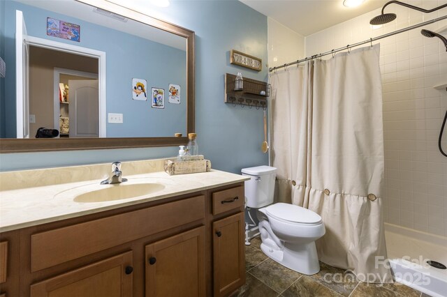 3186 Helmsley Ct, Concord, NC 28027 - bathroom with vanity, toilet, tiled shower, and visible vents