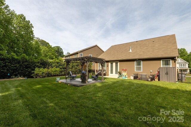 3186 Helmsley Ct, Concord, NC 28027 - back of house featuring a shingled roof, a patio area, a yard, and a pergola