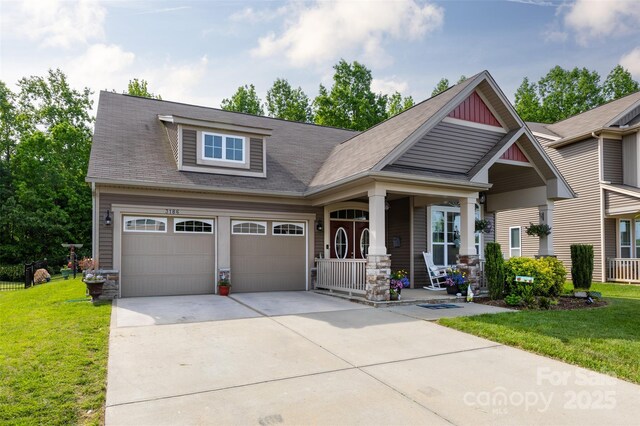 3186 Helmsley Ct, Concord, NC 28027 - craftsman house featuring a shingled roof, an attached garage, a porch, a front yard, and concrete driveway