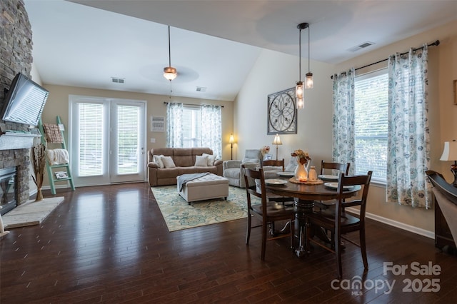 3186 Helmsley Ct, Concord, NC 28027 - dining space with a stone fireplace, a wealth of natural light, lofted ceiling, and wood finished floors