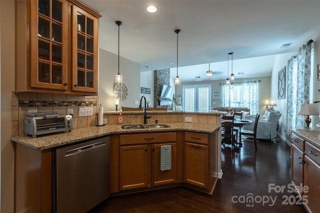 3186 Helmsley Ct, Concord, NC 28027 - kitchen with stainless steel dishwasher, a sink, light stone counters, a peninsula, and open floor plan