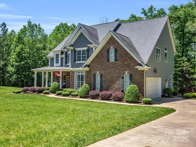 craftsman-style house featuring roof with shingles, brick siding, a garage, a front yard, and concrete driveway