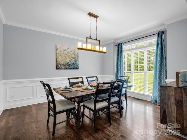dining space featuring crown molding, dark wood-style flooring, a wainscoted wall, and visible vents