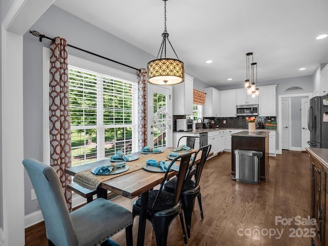 dining space with recessed lighting, baseboards, and dark wood-style floors