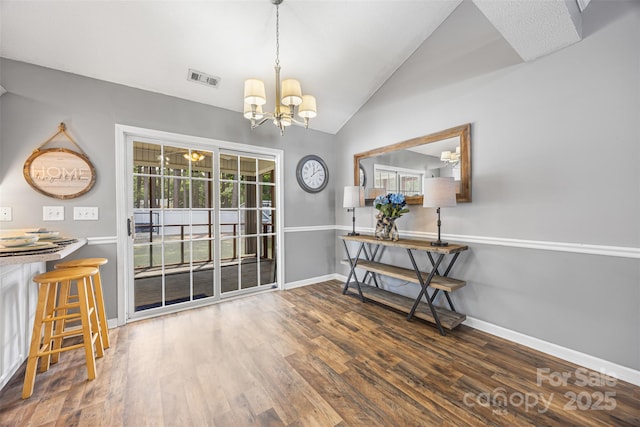 311 Masters Dr, Rock Hill, SC 29732 - dining room featuring a chandelier, vaulted ceiling, baseboards, and wood finished floors