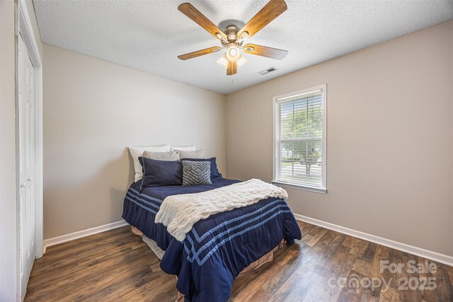 311 Masters Dr, Rock Hill, SC 29732 - bedroom featuring baseboards, dark wood-type flooring, a textured ceiling, ceiling fan, and a closet