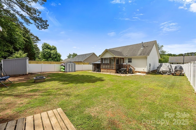 311 Masters Dr, Rock Hill, SC 29732 - rear view of property featuring a shed, a sunroom, an outbuilding, a fire pit, and a shingled roof