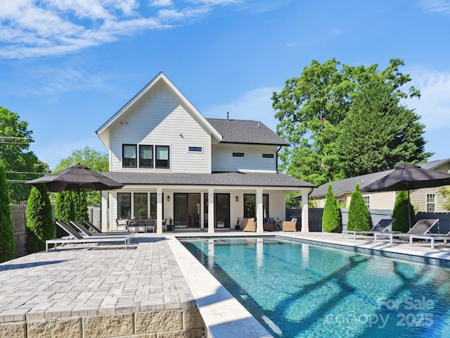 view of swimming pool featuring fence, a patio area, and a fenced in pool