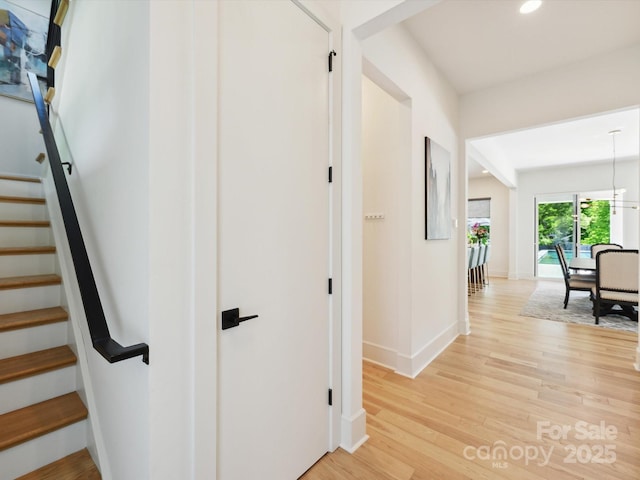 stairway featuring baseboards, recessed lighting, and wood finished floors