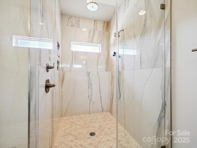 bathroom with a marble finish shower