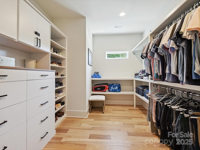walk in closet featuring light wood-style floors and visible vents