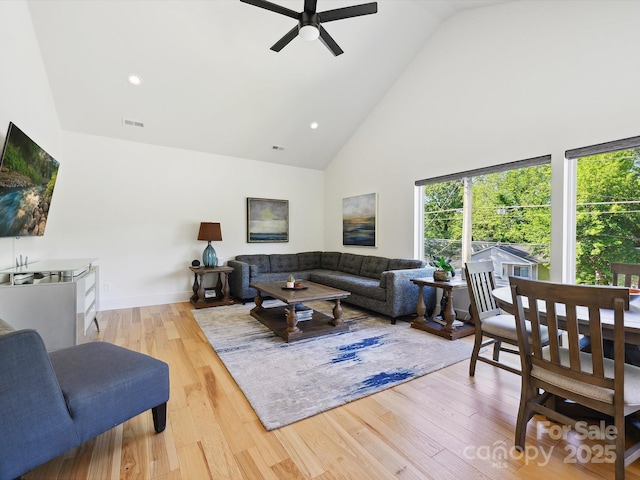 living room with visible vents, wood finished floors, ceiling fan, high vaulted ceiling, and recessed lighting