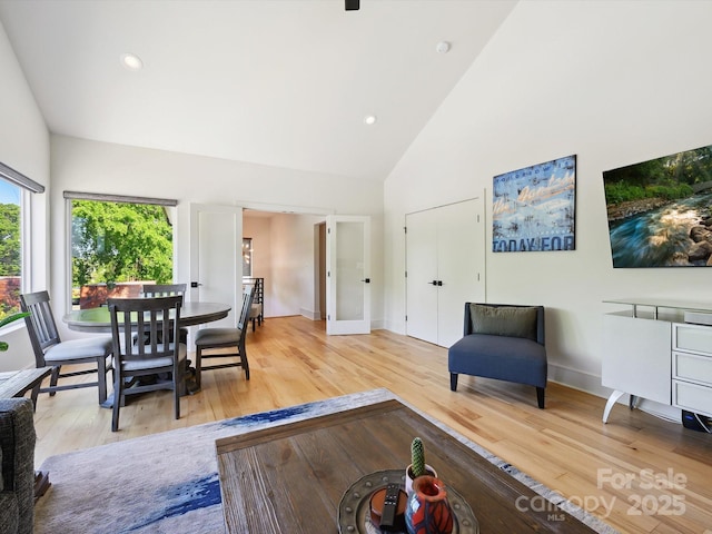 living room featuring recessed lighting, high vaulted ceiling, and light wood finished floors
