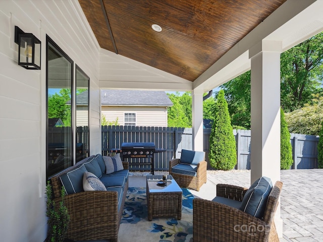 view of patio / terrace featuring area for grilling, fence, and an outdoor living space