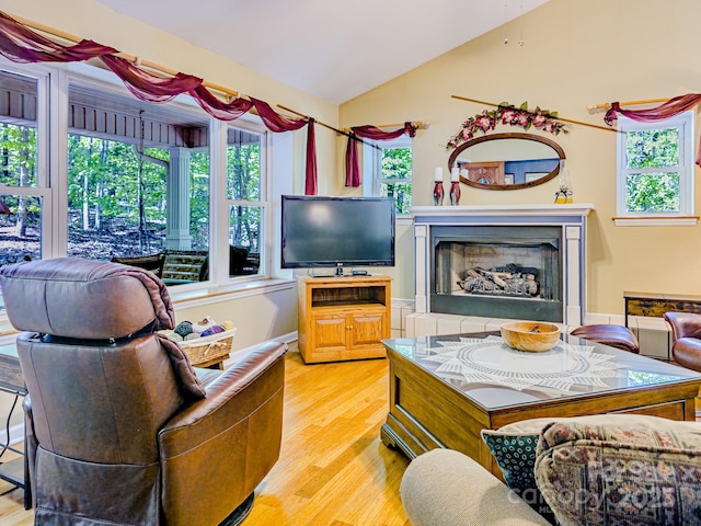 164 Forest Ridge Dr, Rutherfordton, NC 28139 - living area with a fireplace with raised hearth, vaulted ceiling, and light wood finished floors