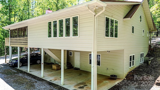 164 Forest Ridge Dr, Rutherfordton, NC 28139 - exterior space featuring driveway, a chimney, a sunroom, and a carport