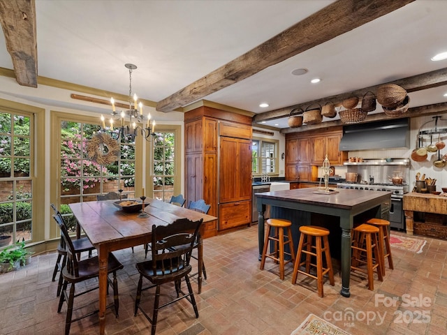 dining space with beamed ceiling, a chandelier, recessed lighting, and brick patterned flooring