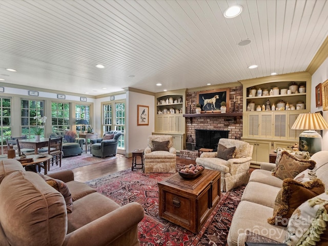 living area with crown molding, wood finished floors, recessed lighting, a fireplace, and wooden ceiling