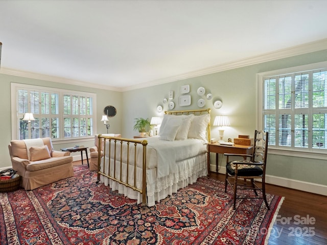 bedroom featuring crown molding, wood finished floors, and baseboards